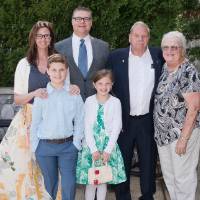 Award winner poses with family (outdoors)